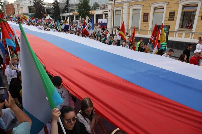 Участники «Парада регионов» в Нижнем Новгороде в День России пронесли по центральной улице города стометровый триколор